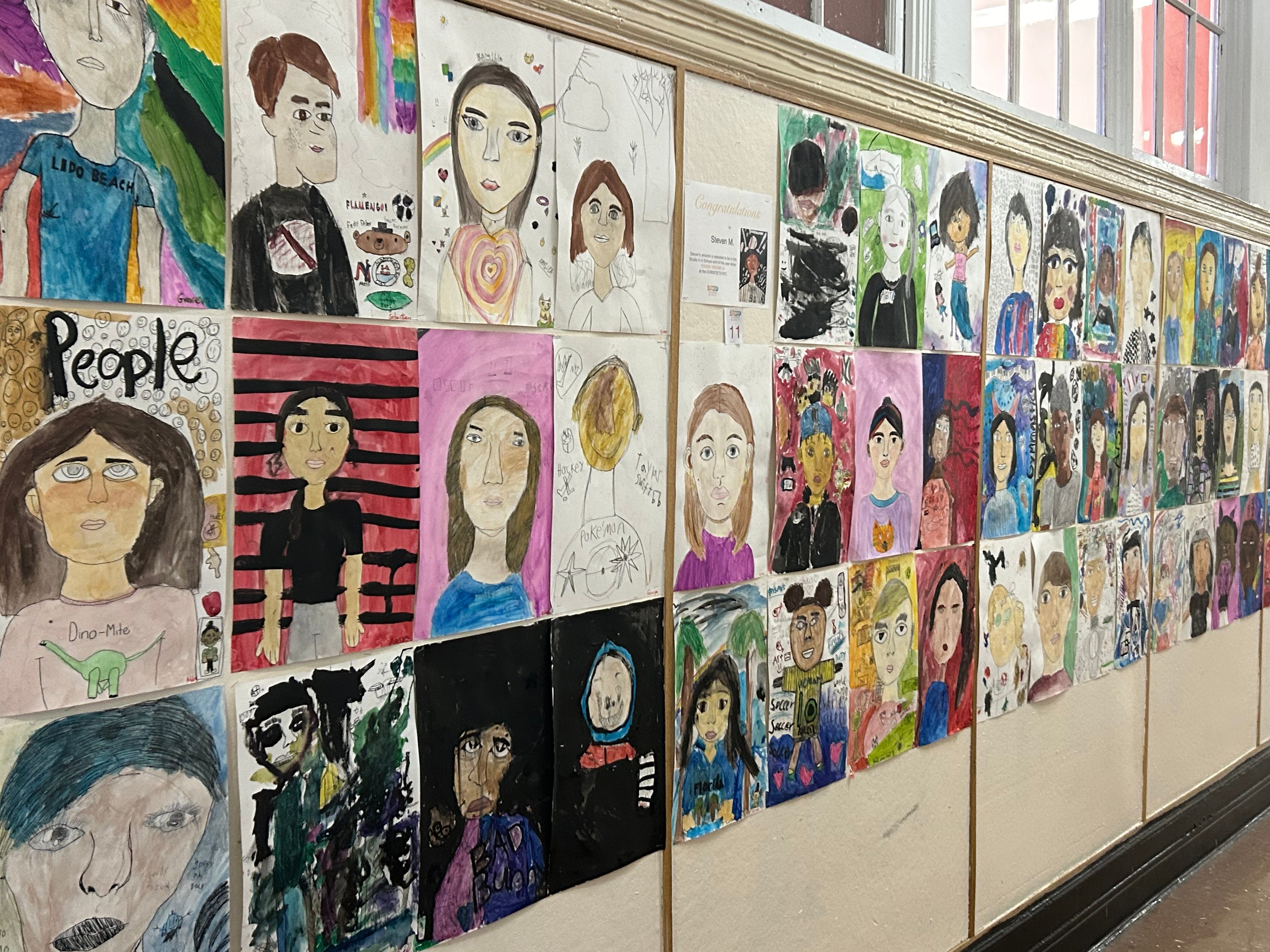 4th/5th grade student self-portraits hung in our hallway